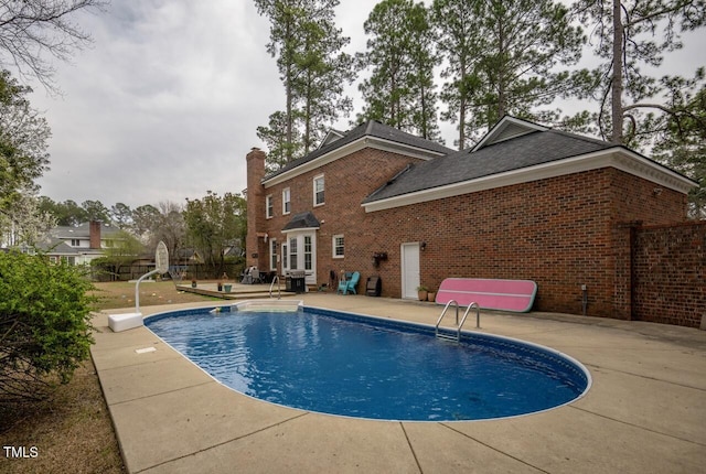 view of pool with a fenced in pool, a patio, and fence