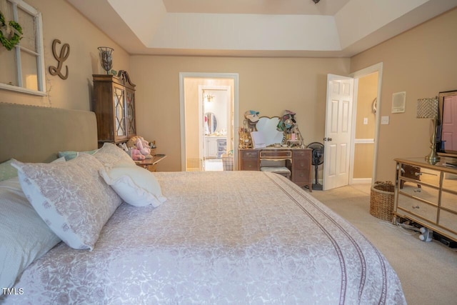 bedroom with ensuite bath and carpet