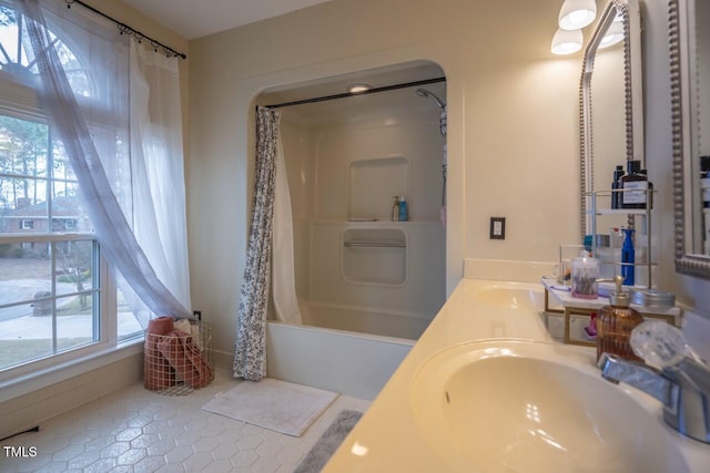 bathroom featuring double vanity, tile patterned floors, shower / bathtub combination with curtain, and a sink