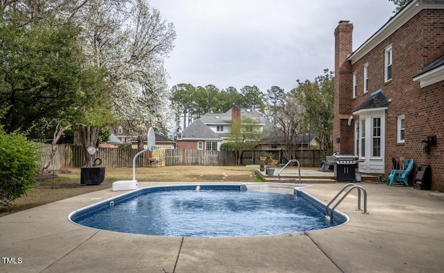 view of pool featuring a patio area, area for grilling, a fenced in pool, and a fenced backyard