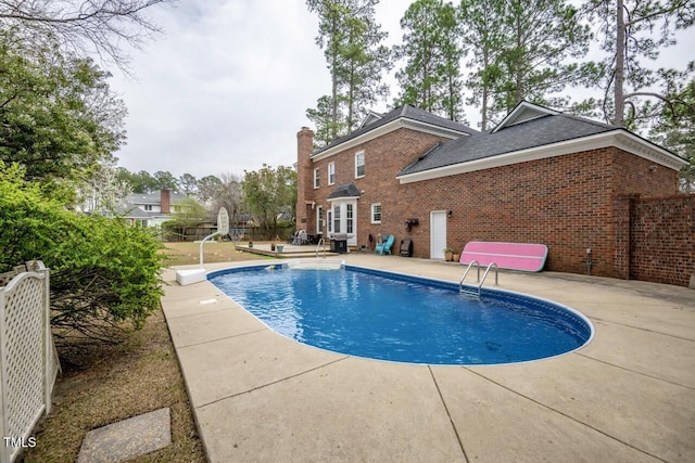 view of pool with a fenced in pool, a patio area, and fence