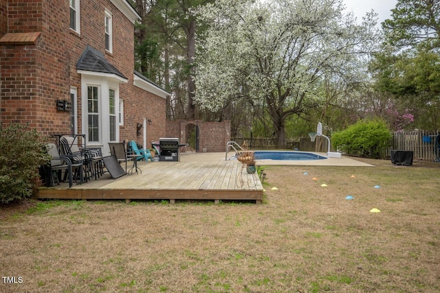 view of yard with a deck, a fenced in pool, and a fenced backyard