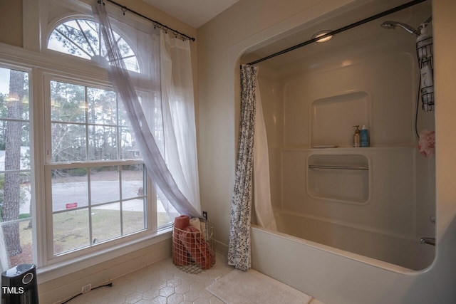 bathroom featuring tile patterned flooring and shower / tub combo