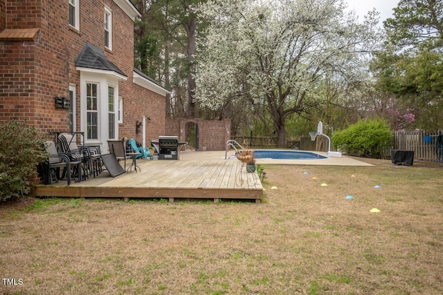 exterior space featuring a fenced in pool, a deck, and fence