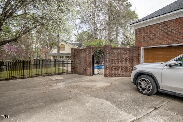 exterior space featuring fence, brick siding, and a gate