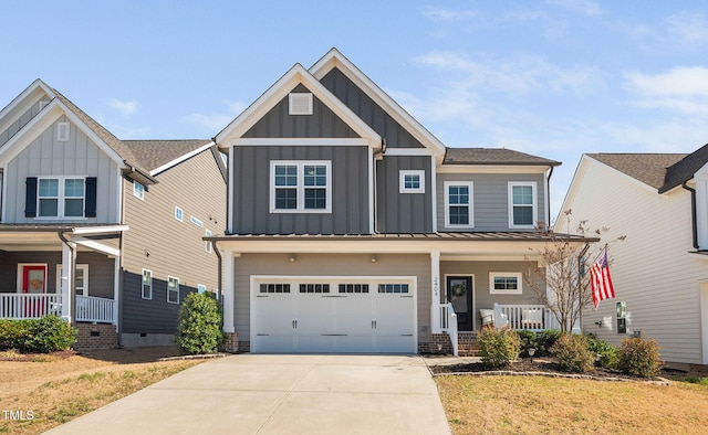 craftsman inspired home featuring a standing seam roof, covered porch, concrete driveway, a garage, and board and batten siding