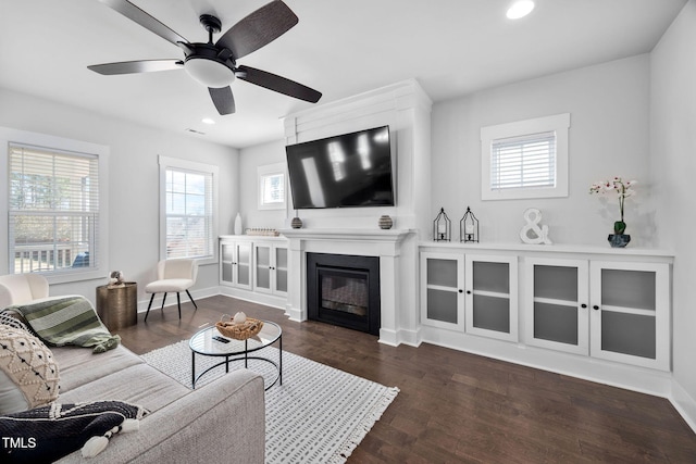 living room with dark wood finished floors, recessed lighting, a fireplace, and baseboards