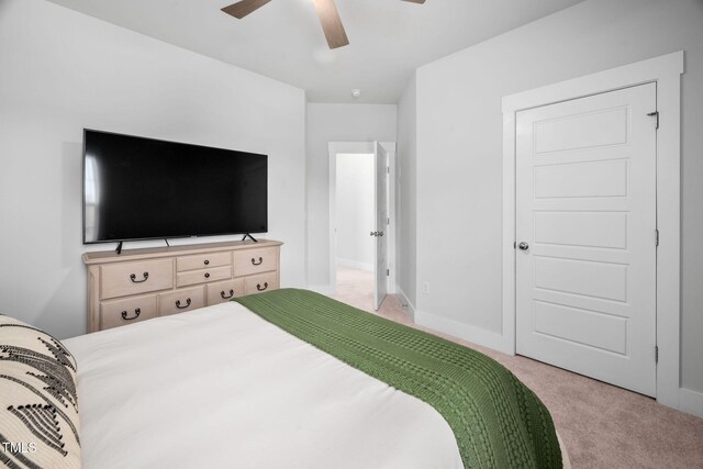 bedroom with baseboards, carpet floors, and a ceiling fan