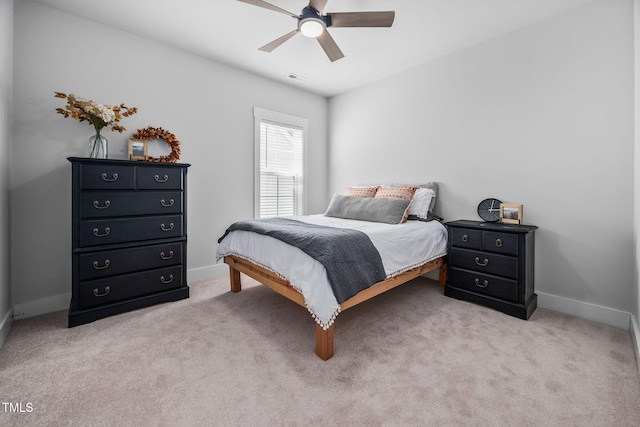 bedroom featuring a ceiling fan, visible vents, baseboards, and carpet floors