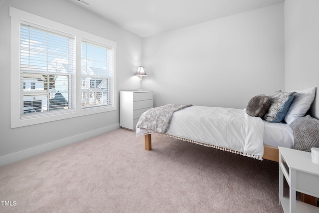 bedroom featuring visible vents, baseboards, and carpet floors