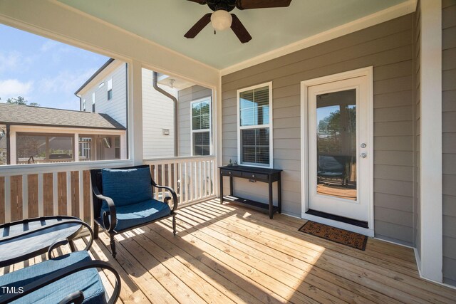 wooden deck featuring a ceiling fan