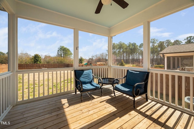 deck with a ceiling fan and fence