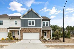 view of front of home with a garage, board and batten siding, and concrete driveway