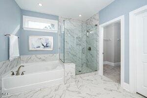 full bath featuring a garden tub, recessed lighting, marble finish floor, and a marble finish shower