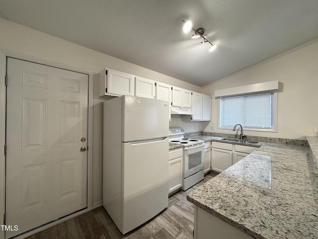 kitchen featuring white appliances, a sink, vaulted ceiling, under cabinet range hood, and white cabinetry