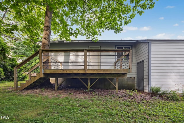 back of property featuring a deck and stairs