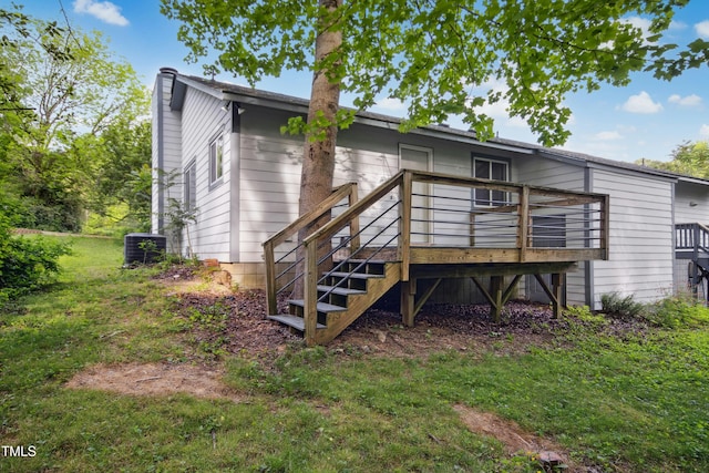 rear view of property with a wooden deck, a chimney, and cooling unit