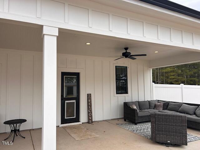 view of patio / terrace featuring an outdoor living space, a ceiling fan, and a garage