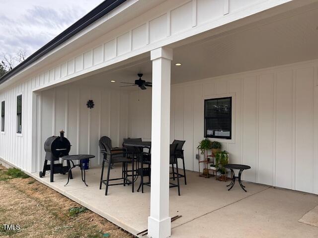 view of patio with outdoor dining area and ceiling fan