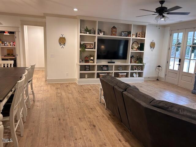 living room featuring light wood finished floors, baseboards, recessed lighting, french doors, and a ceiling fan