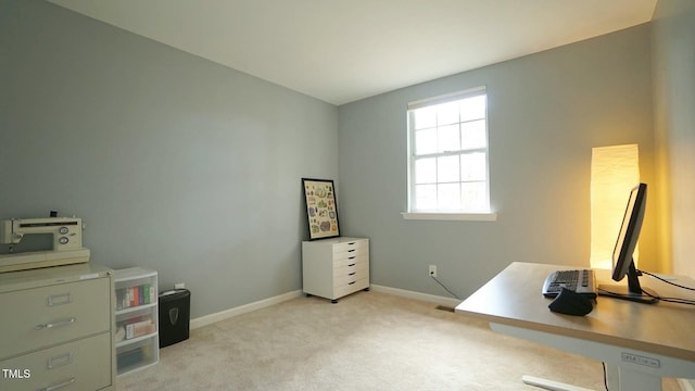 carpeted home office with baseboards