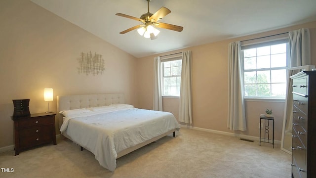 bedroom with visible vents, multiple windows, light colored carpet, and lofted ceiling