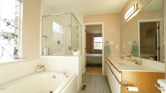 bathroom featuring tile patterned floors, ensuite bathroom, a sink, a shower stall, and a bath