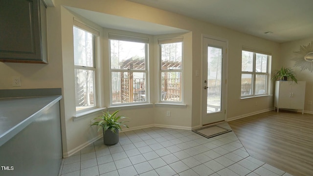 entryway with light tile patterned floors and baseboards