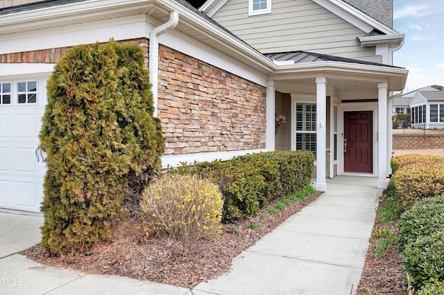 doorway to property with a garage