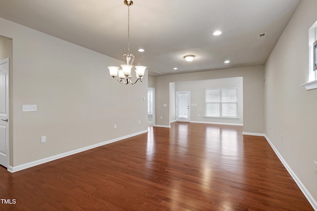 interior space featuring recessed lighting, wood-type flooring, an inviting chandelier, baseboards, and a healthy amount of sunlight