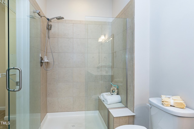 full bath featuring toilet and a shower stall