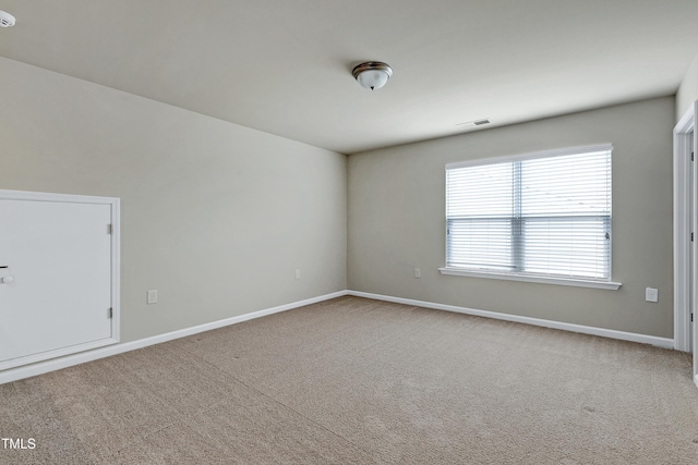 unfurnished room featuring carpet flooring, baseboards, and visible vents