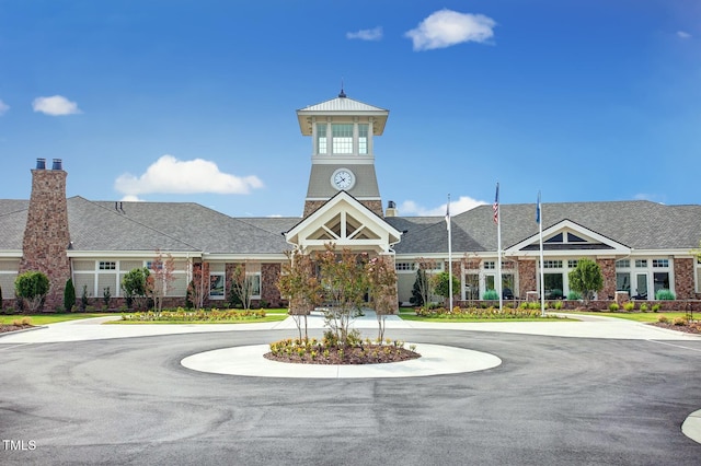 view of building exterior with curved driveway