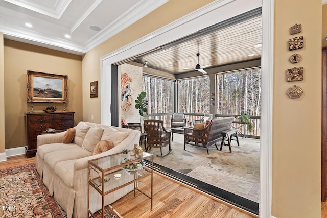 living area featuring recessed lighting, wood finished floors, baseboards, and ornamental molding