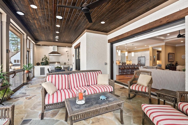 view of patio featuring ceiling fan, exterior kitchen, a grill, and an outdoor hangout area