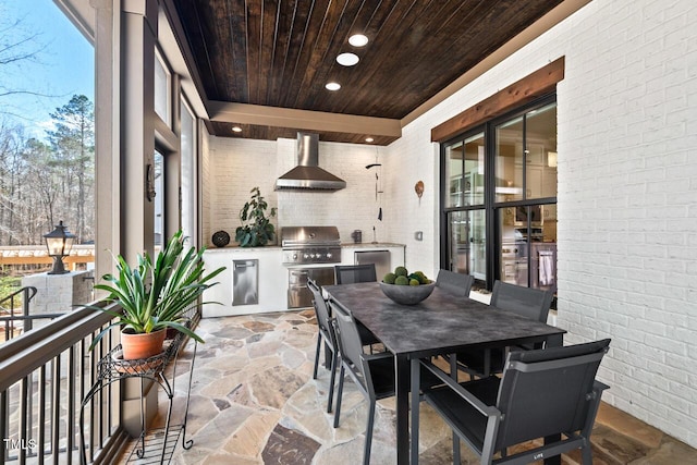 view of patio / terrace featuring outdoor dining space, exterior kitchen, and grilling area