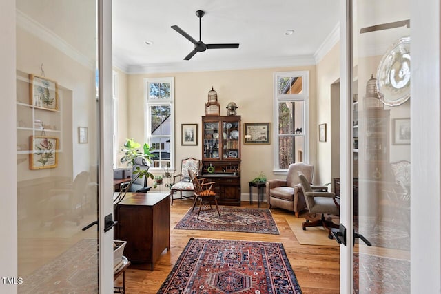 home office featuring ornamental molding, wood finished floors, french doors, baseboards, and ceiling fan