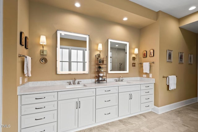 bathroom featuring double vanity, recessed lighting, baseboards, and a sink