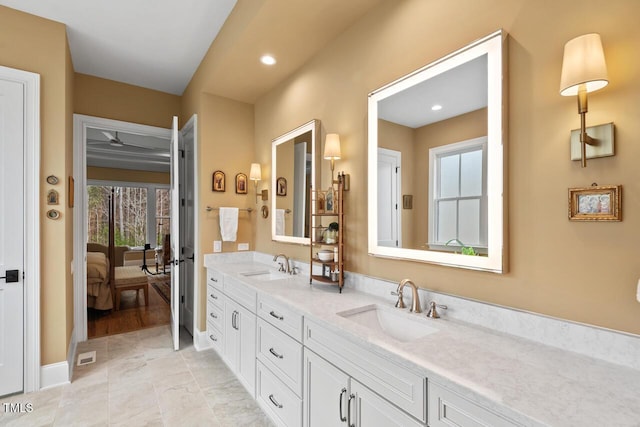 bathroom featuring a sink, connected bathroom, recessed lighting, and double vanity