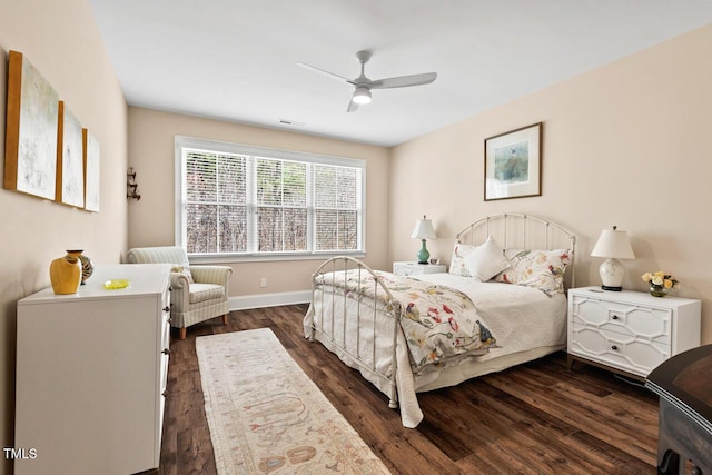 bedroom featuring a ceiling fan, visible vents, baseboards, and dark wood-style flooring