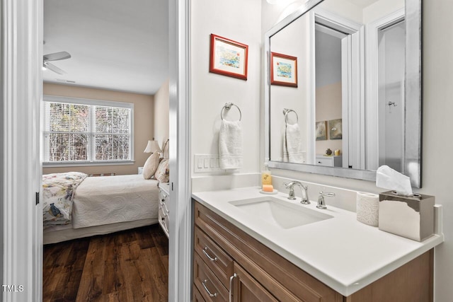 ensuite bathroom featuring ceiling fan, ensuite bathroom, wood finished floors, and vanity