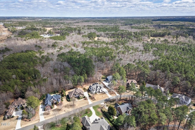 drone / aerial view featuring a residential view and a forest view