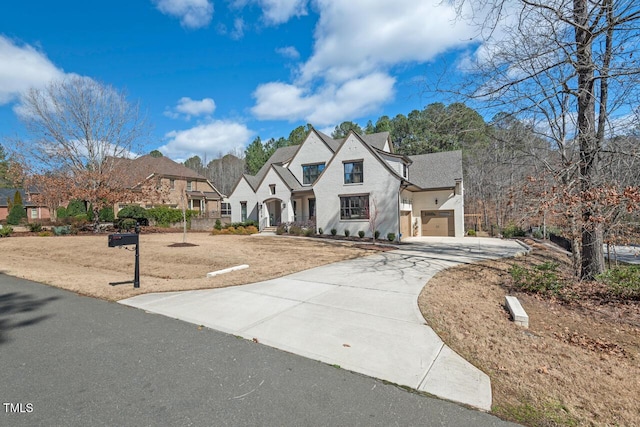 french country home featuring driveway