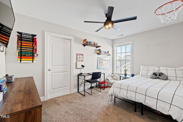 carpeted bedroom featuring baseboards and a ceiling fan