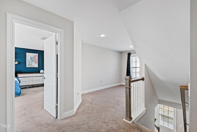 corridor with recessed lighting, baseboards, an upstairs landing, and carpet flooring