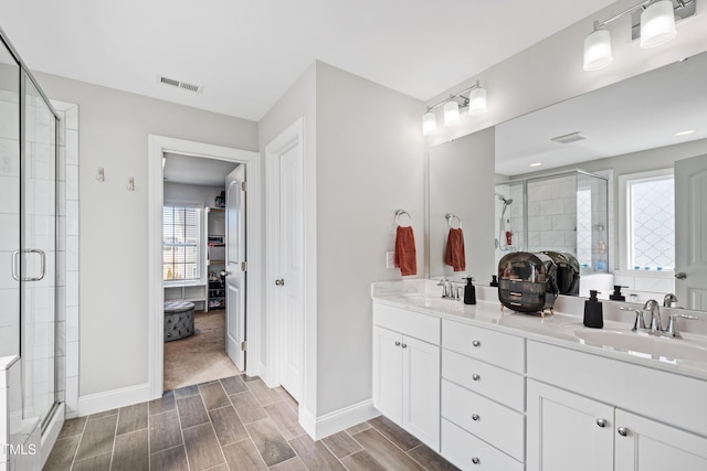 full bath featuring a stall shower, visible vents, and a sink