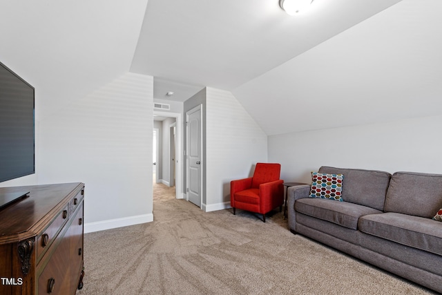 living area with lofted ceiling, light colored carpet, and baseboards