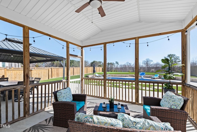 exterior space featuring ceiling fan and vaulted ceiling