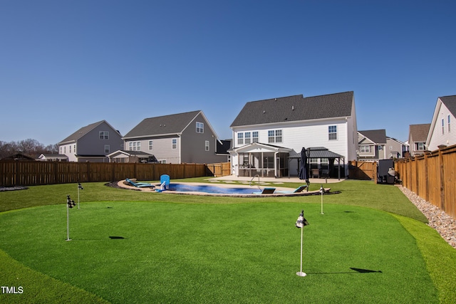 exterior space with a fenced in pool, a residential view, a gazebo, a fenced backyard, and a patio