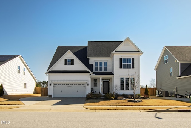 traditional-style home with concrete driveway, cooling unit, and fence